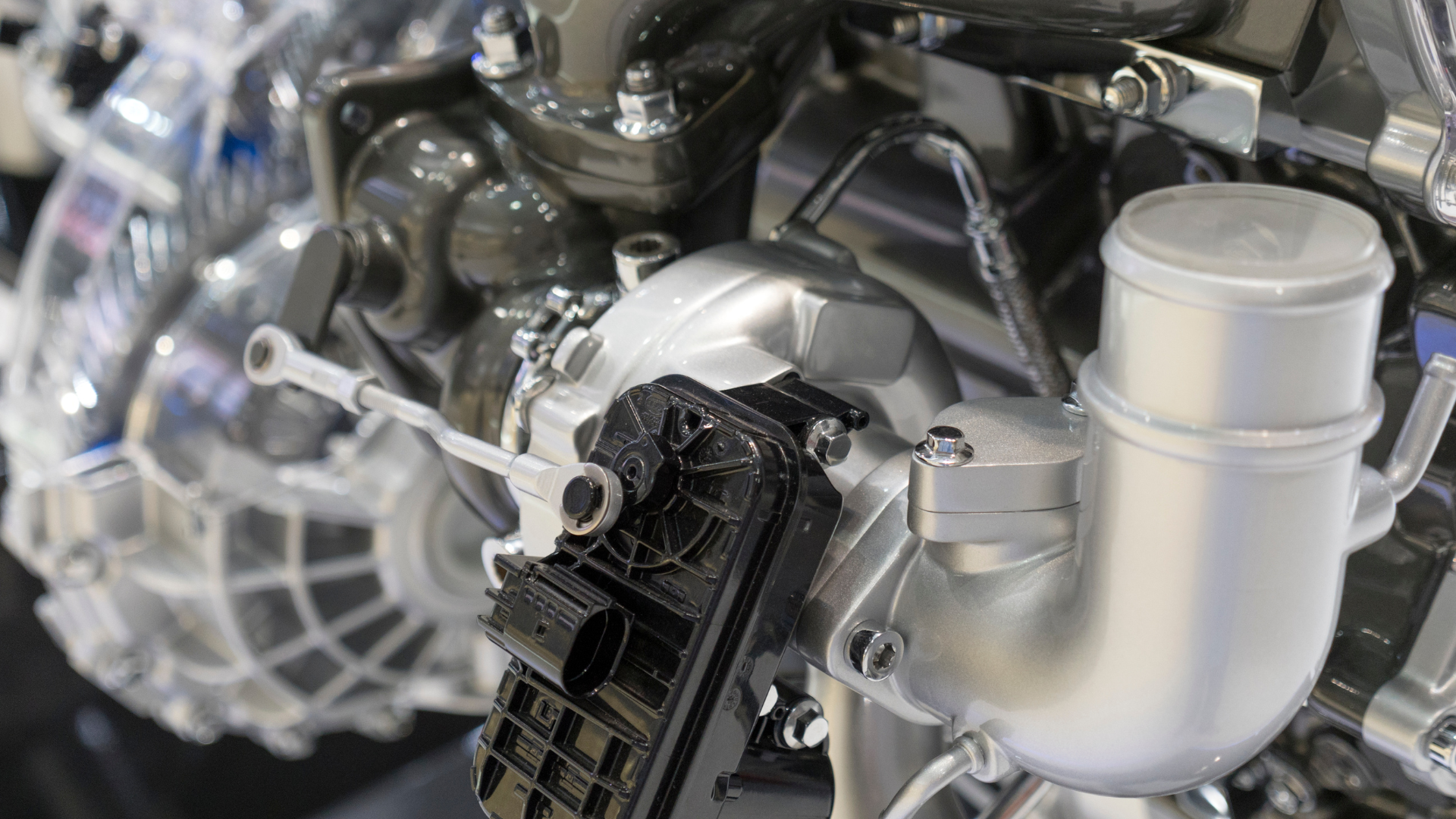 A close up of a turbocharger on a car engine.