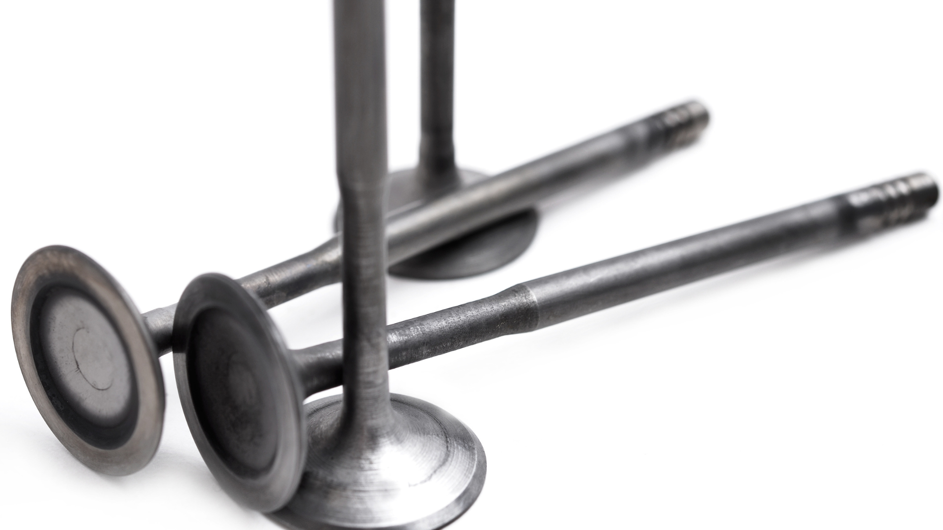 Three valves are stacked on top of each other on a white surface.