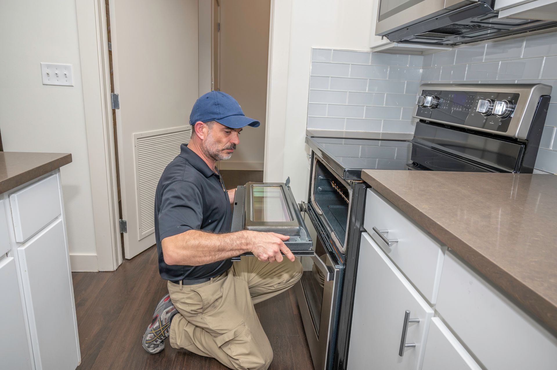 Appliance technician installing an oven door.