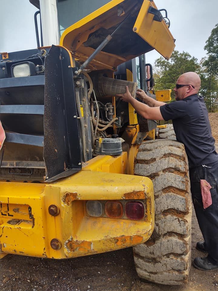 A white road service truck is parked in the snow