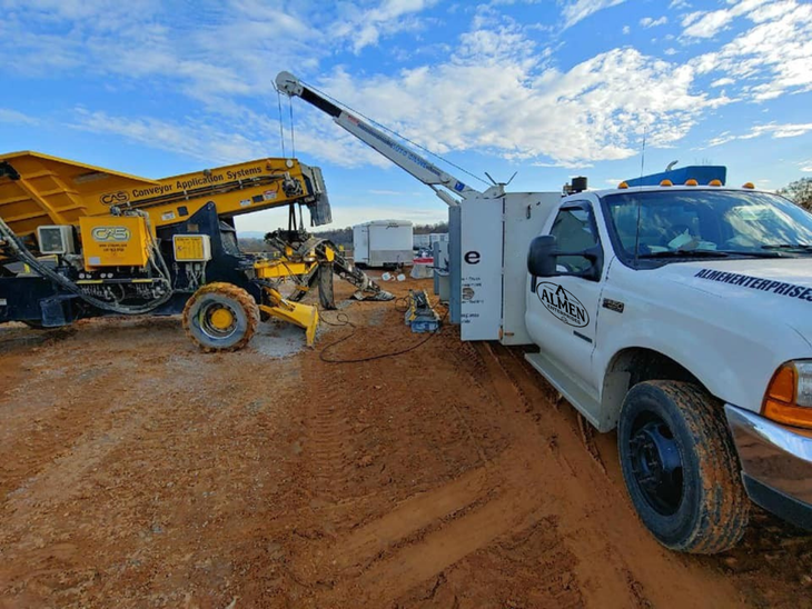 A 24 hr road service truck is parked next to another truck - Almen Enterprises