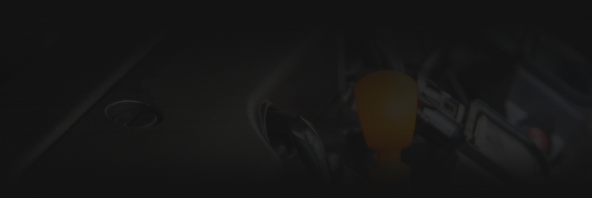 A dark background with a blurred image of a person standing in the dark - Almen Enterprises