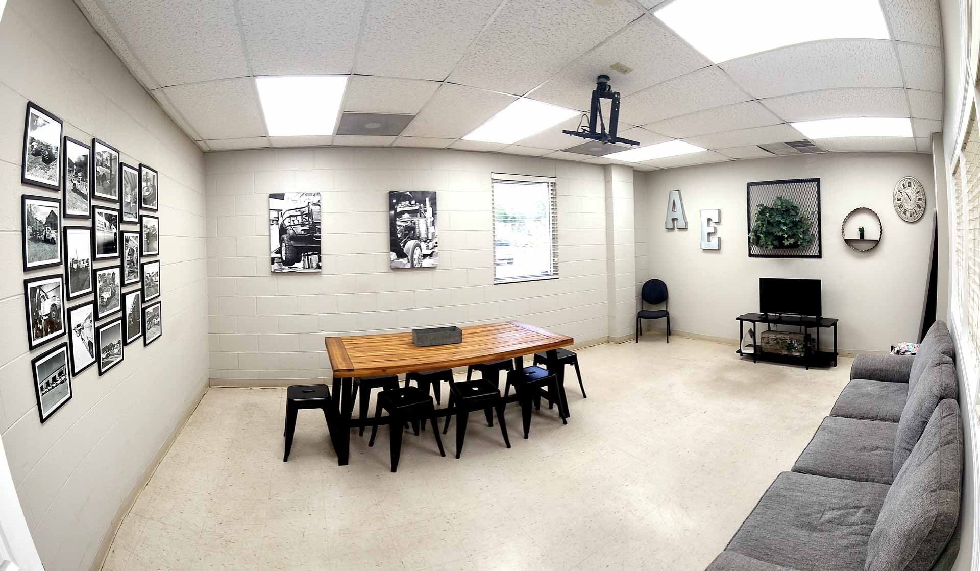 A large room with a table and chairs in it