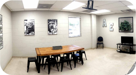 A room with a table and chairs in it - Almen Enterprises