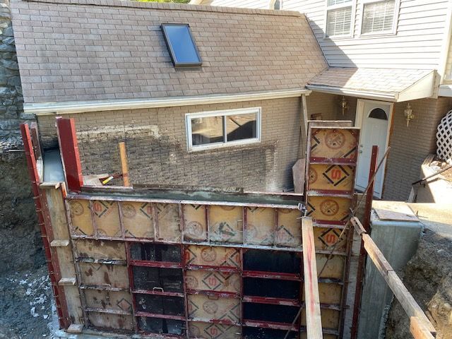An aerial view of a house under construction with a skylight on the roof.