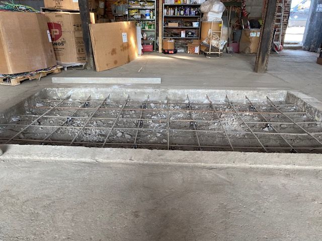 A warehouse with a lot of boxes and a concrete floor.