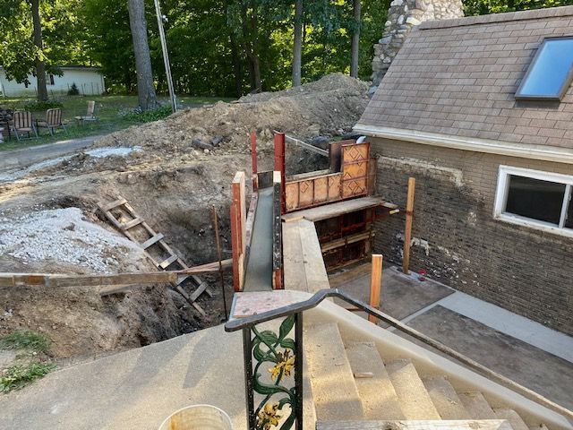 A house is being built with a staircase in the foreground.