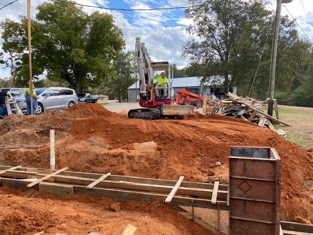A construction site with a pile of dirt and a bulldozer.
