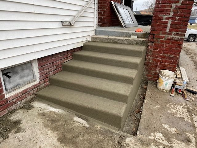 A set of concrete steps leading up to a house.