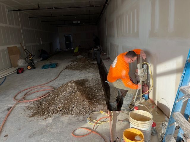 A man is working on a wall in a building.