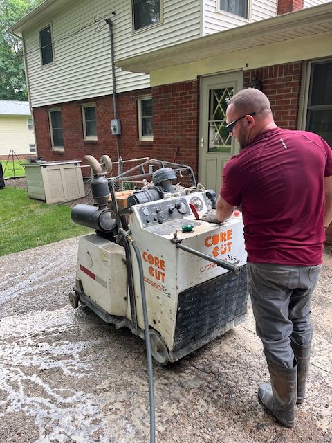 A man is standing next to a machine that says core cut