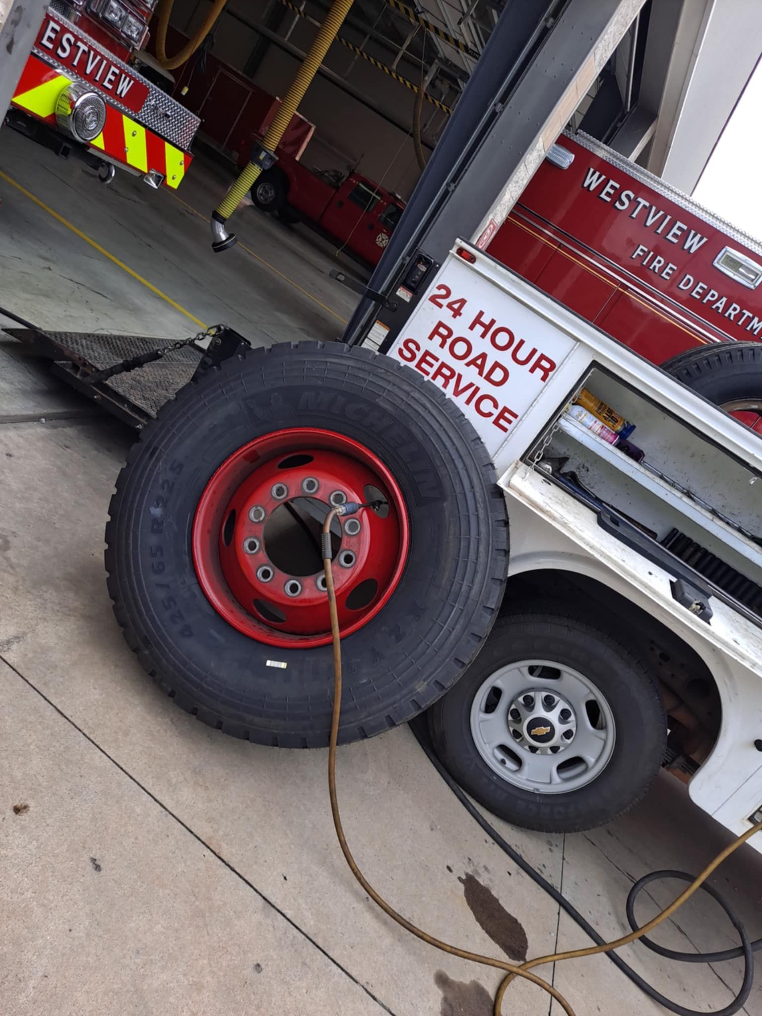 A fire truck has a sign that says 24 hour road service