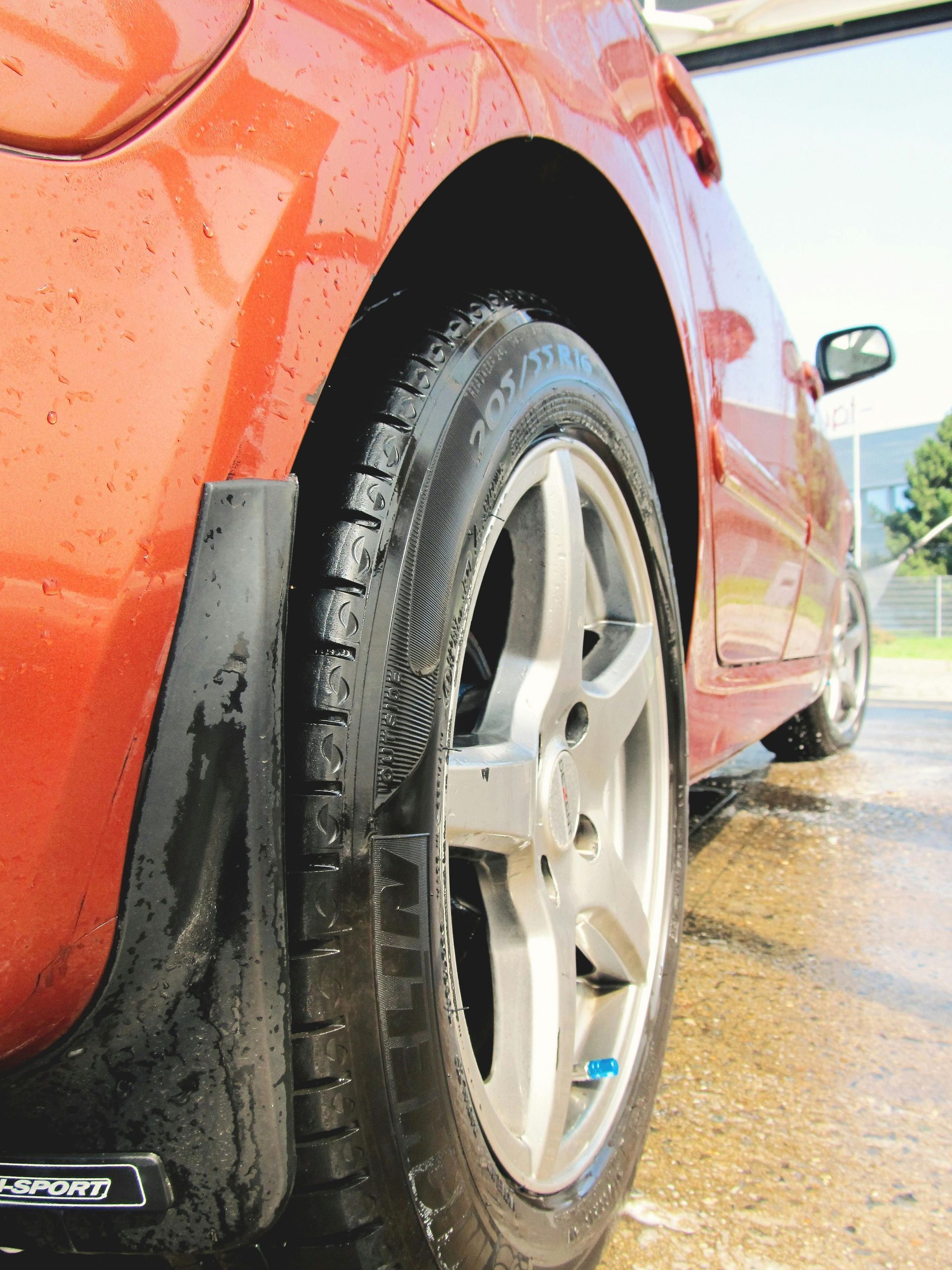A close up of a car wheel with the word sport on it