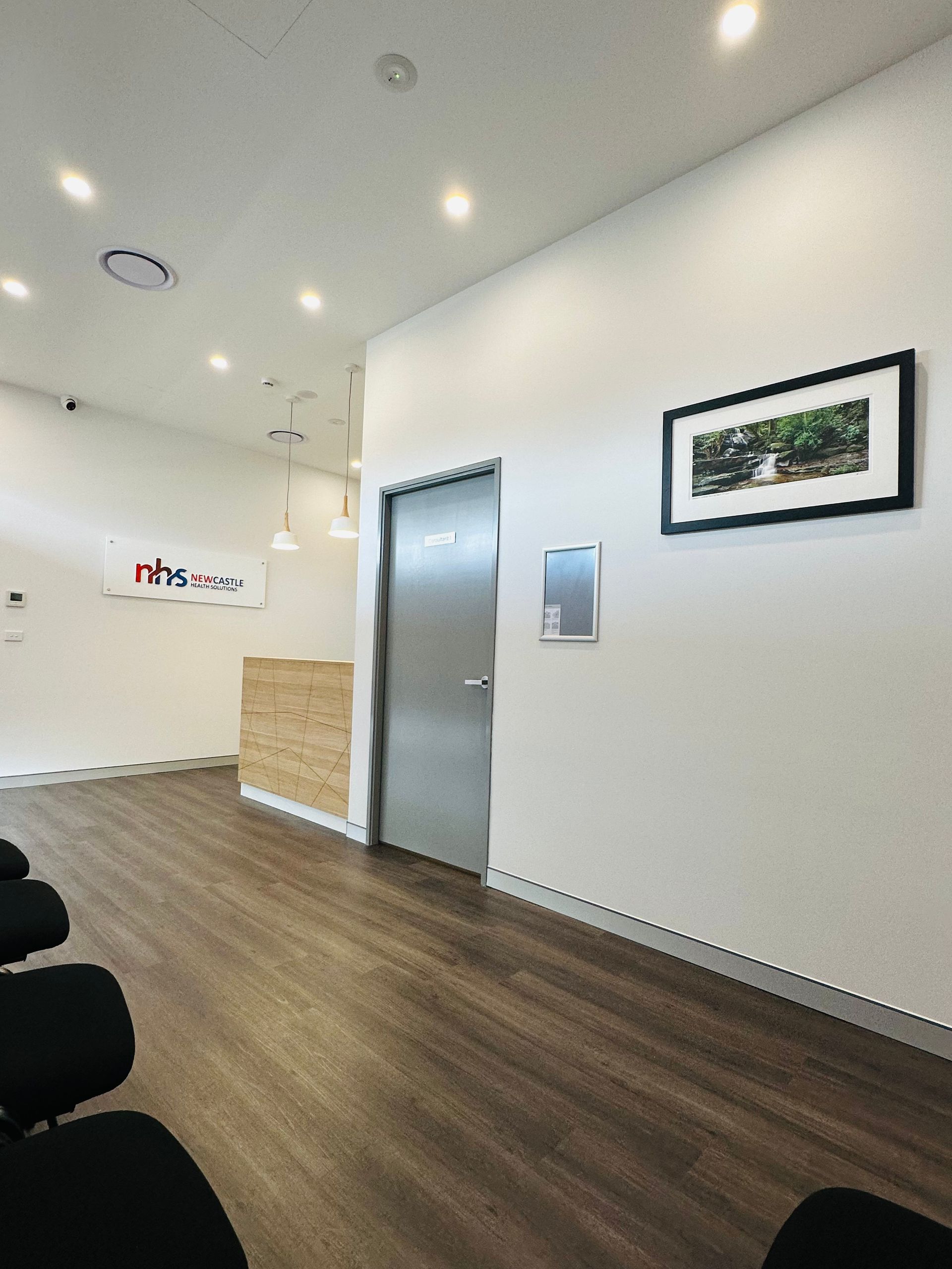 A Waiting Room With Chairs And A Picture On The Wall — Nyon Shopfitters in Morisset, NSW