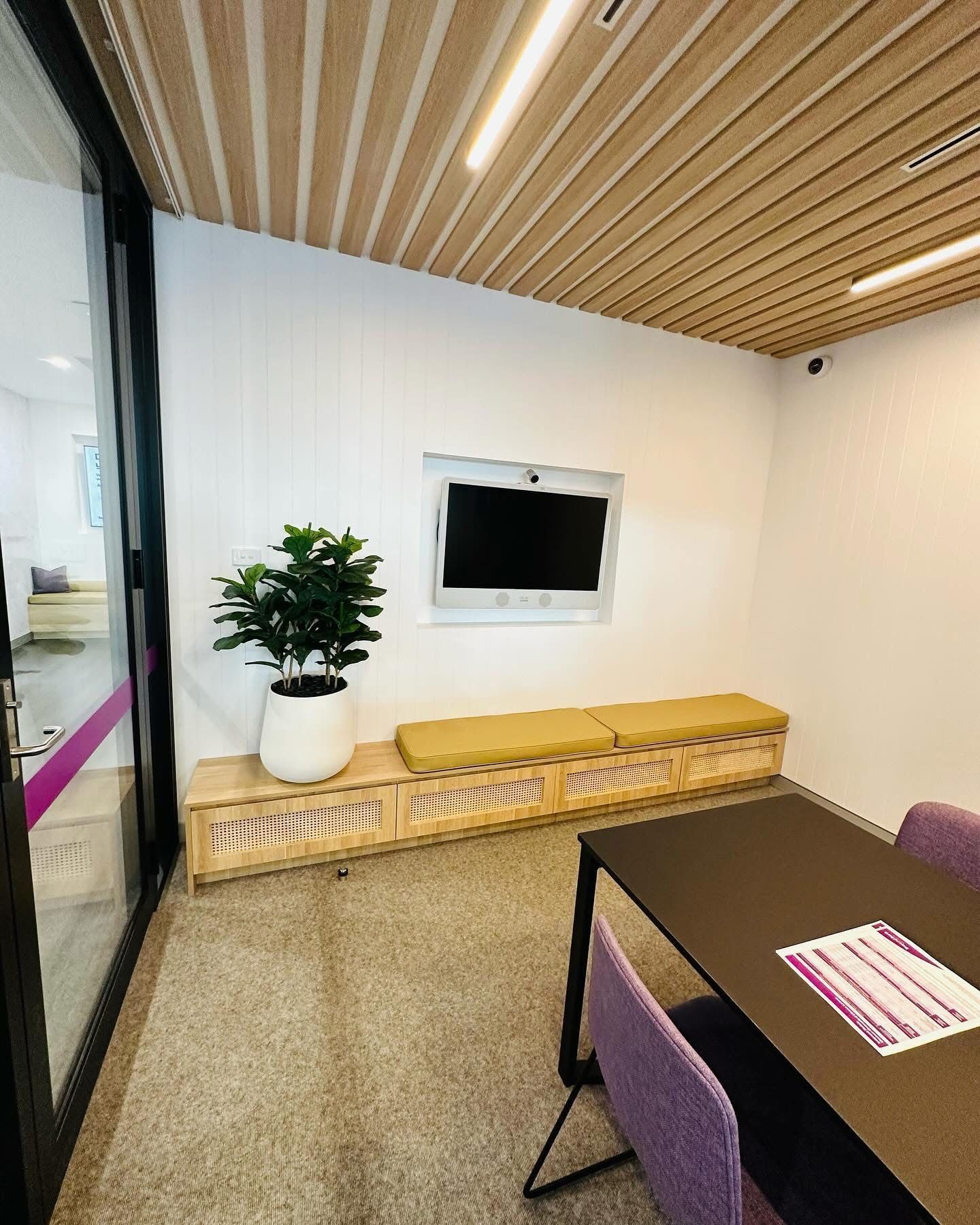 A Office Fitout With a Table, Chairs and a Television On The Wall — Nyon Shopfitters in Morisset, NSW