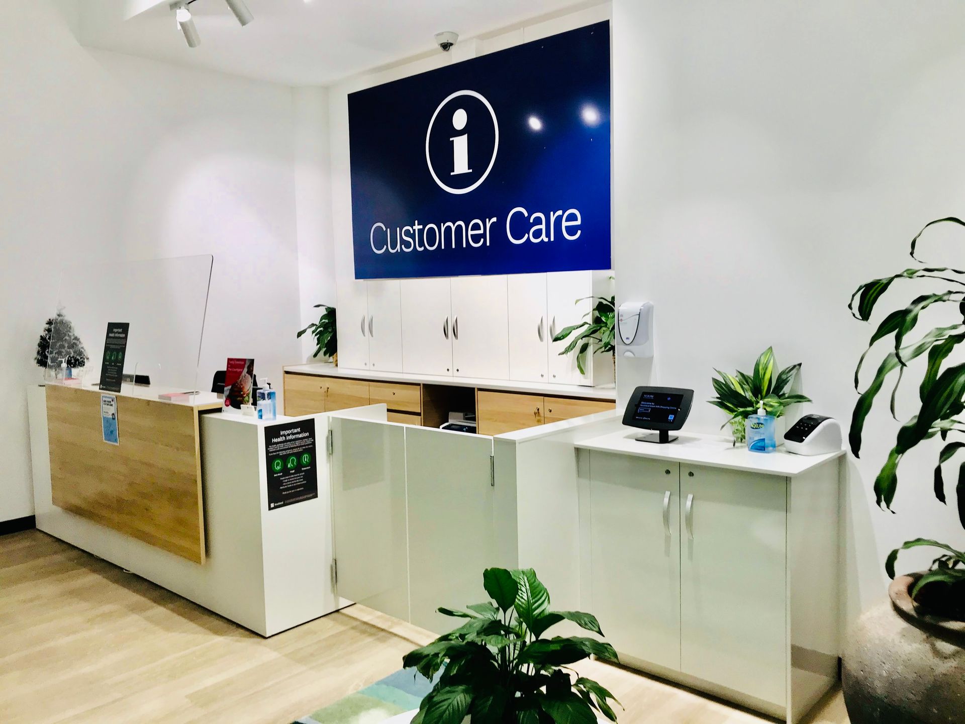 A Reception Area with a Sign That Says Customer Care on it — Nyon Shopfitters in Morisset, NSW