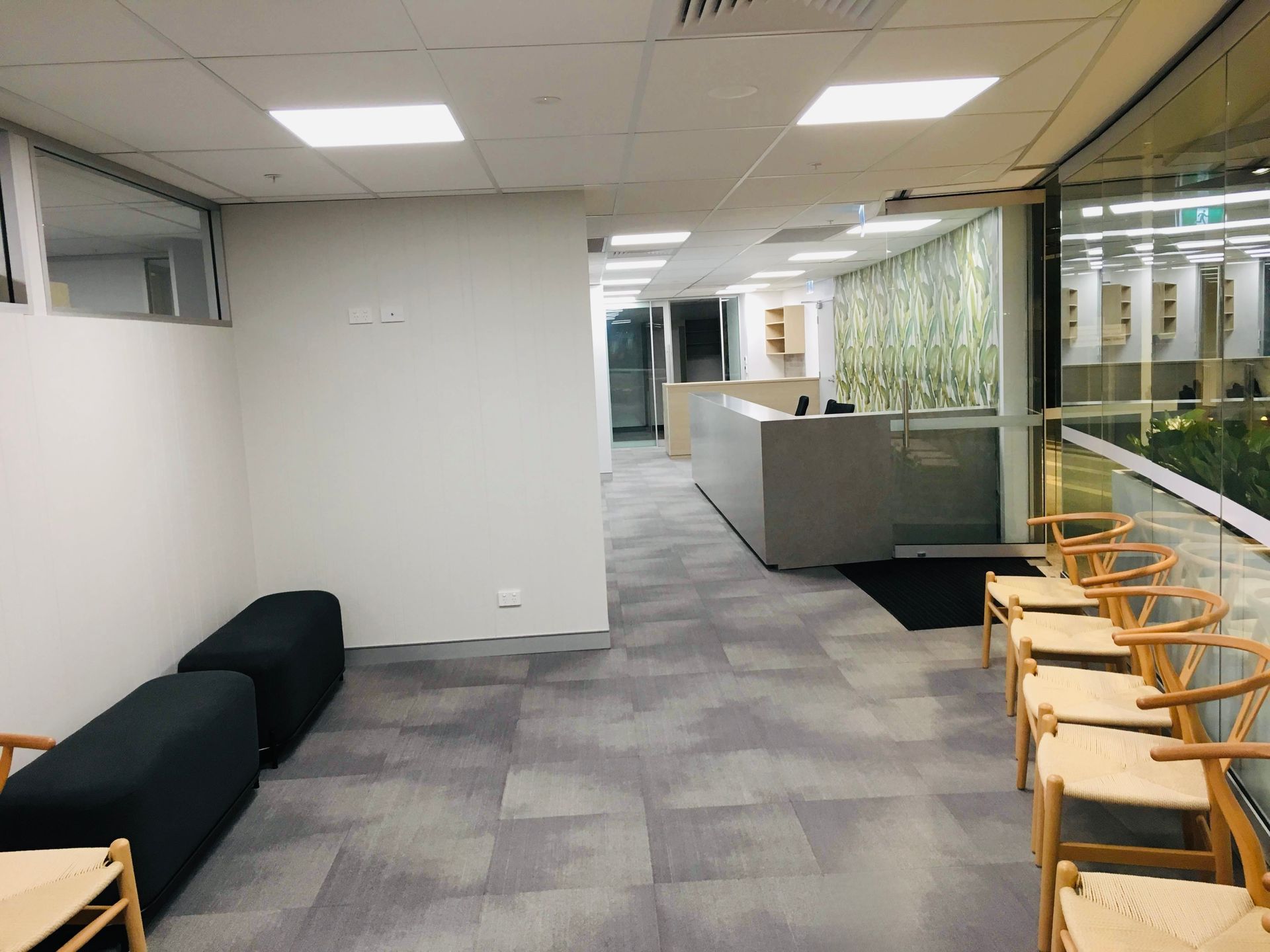 A Waiting Room With a Row of Chairs and Ottomans — Nyon Shopfitters in Morisset, NSW