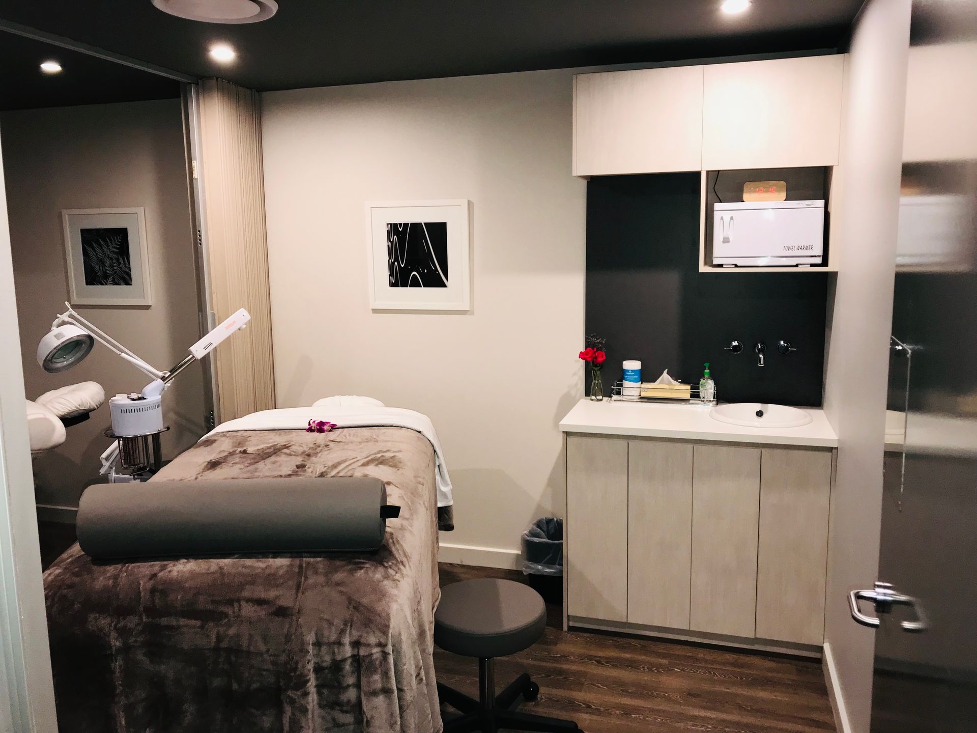 A room with a bed and a sink in it.