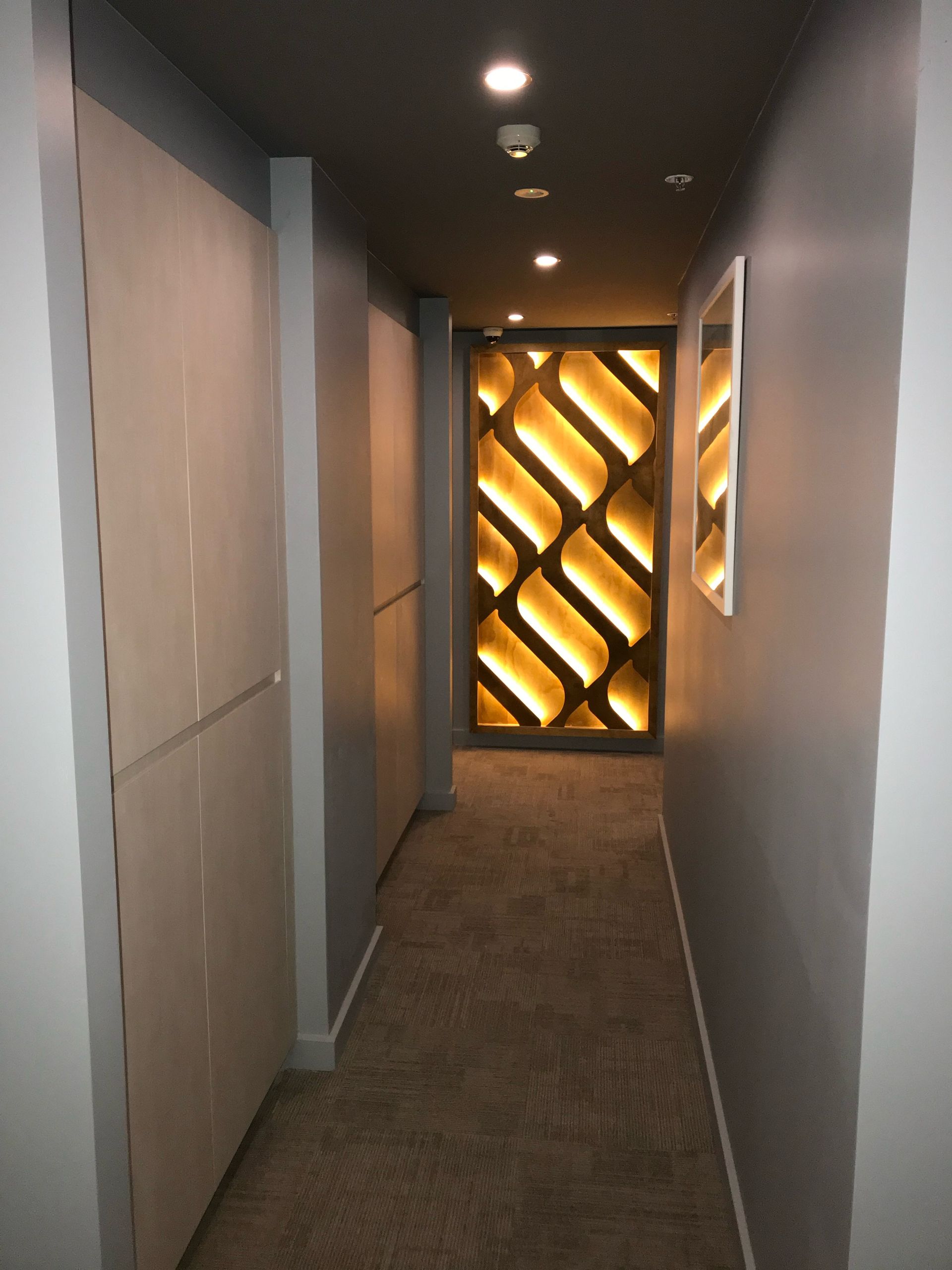 A hallway with a geometric pattern on the wall