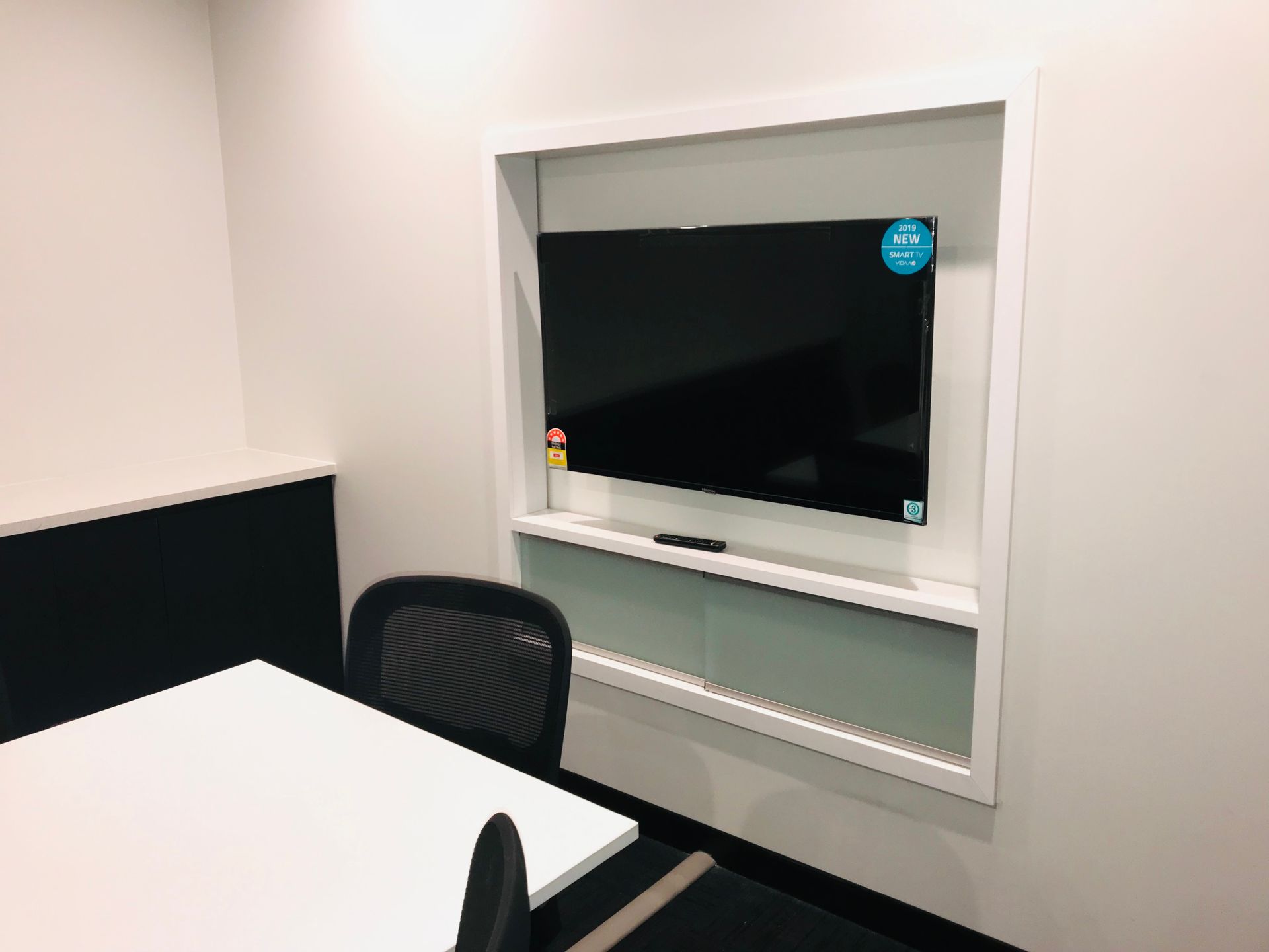 A Conference Room With a Table and and a TV On The Wall — Nyon Shopfitters in Morisset, NSW