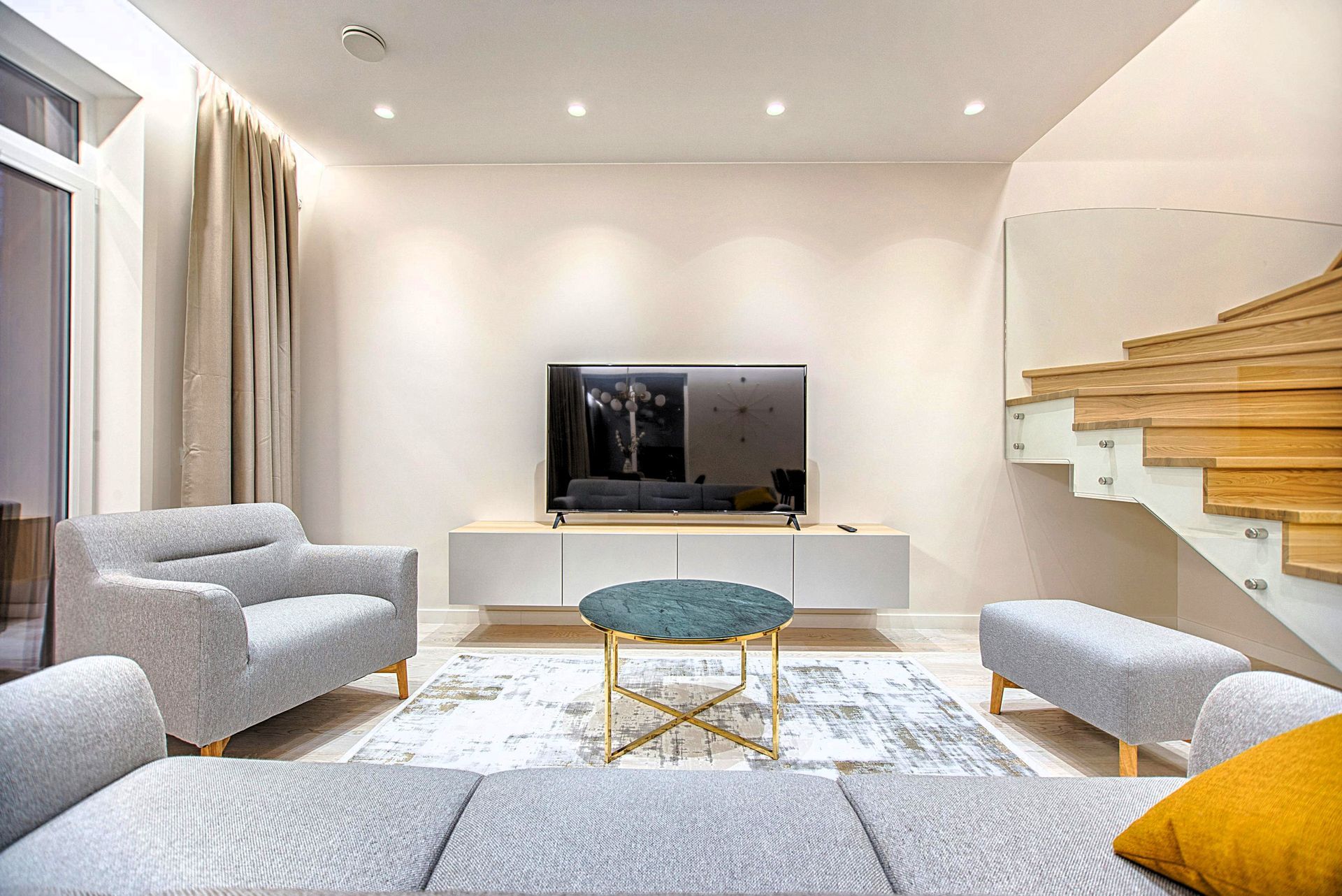 Comfy basement guest room with sofa and TV