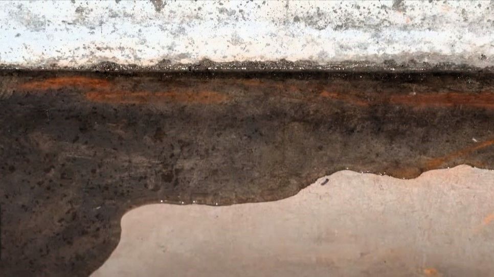 Basement floor with visible water leakage.