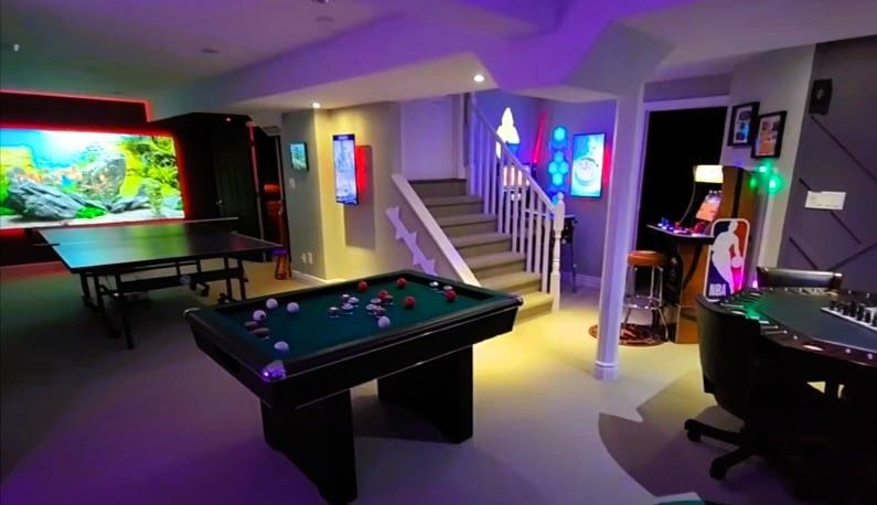Basement game room with pool table, table tennis, and colorful wall art
