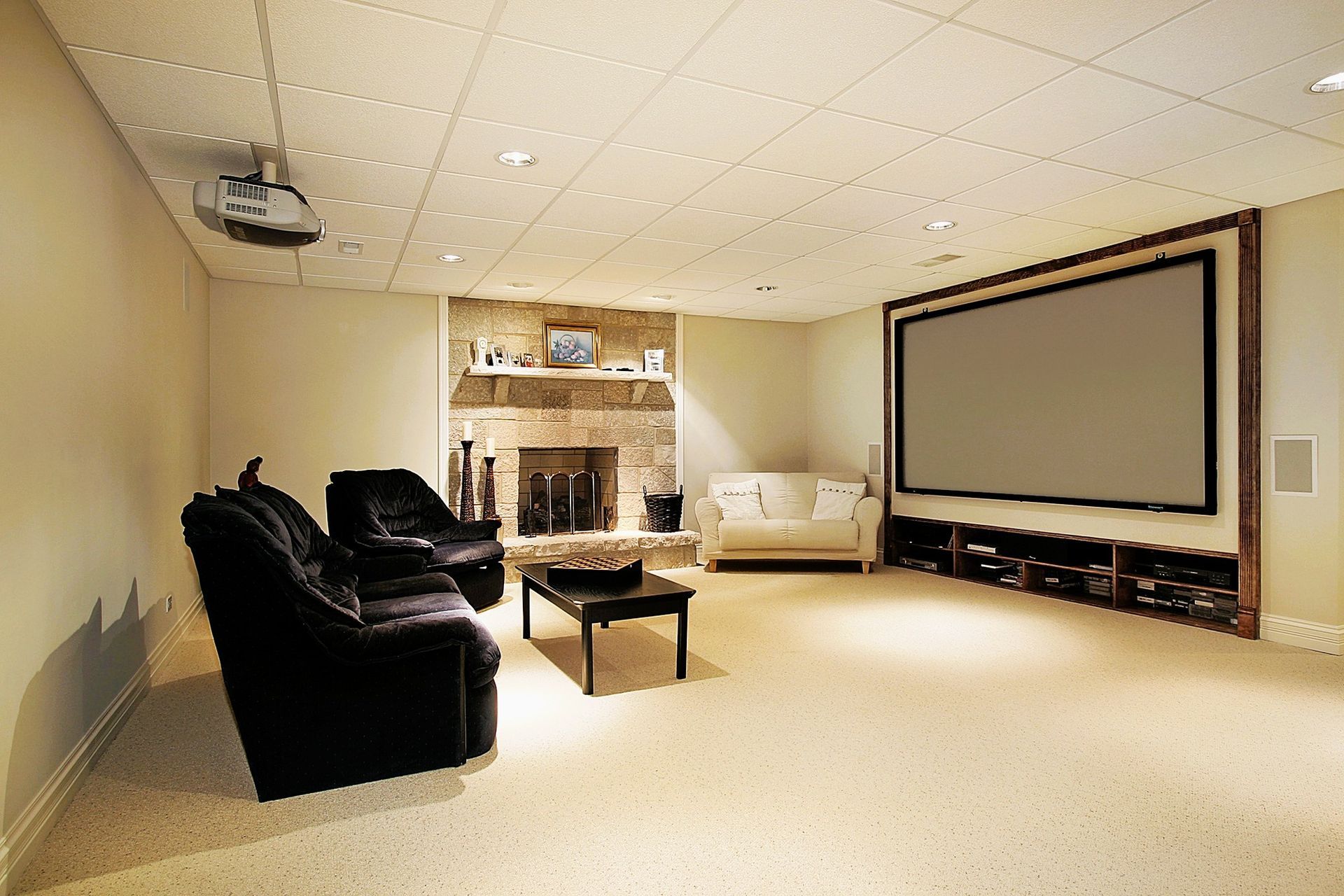 Modern basement media room with projection screen and cozy fireplace