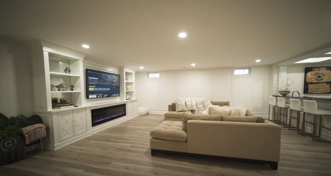 Modern finished basement with cozy furniture for extra living space