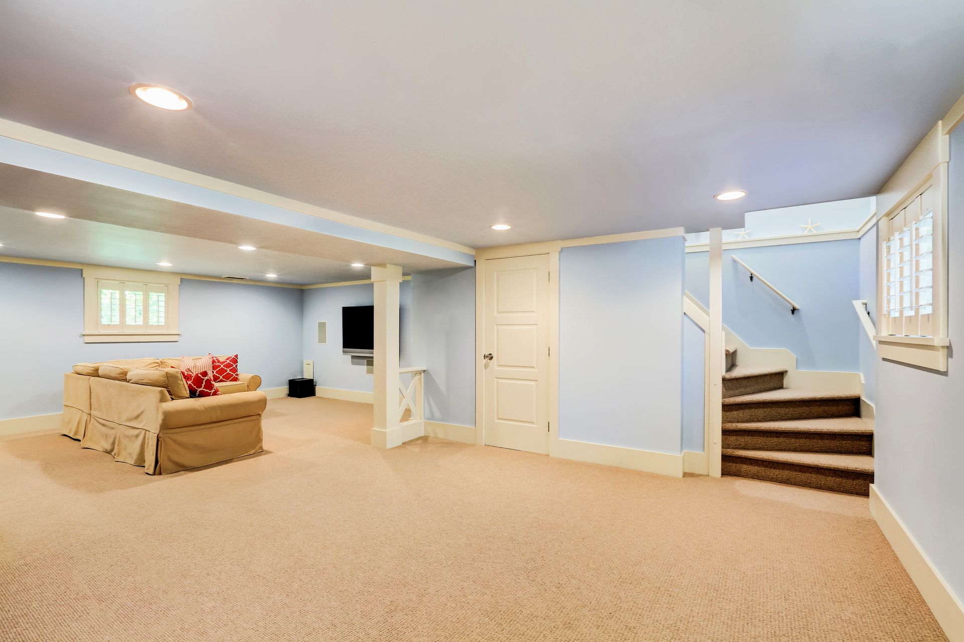 Pastel blue basement interior with cozy sofa in Grand Rapids, MI.