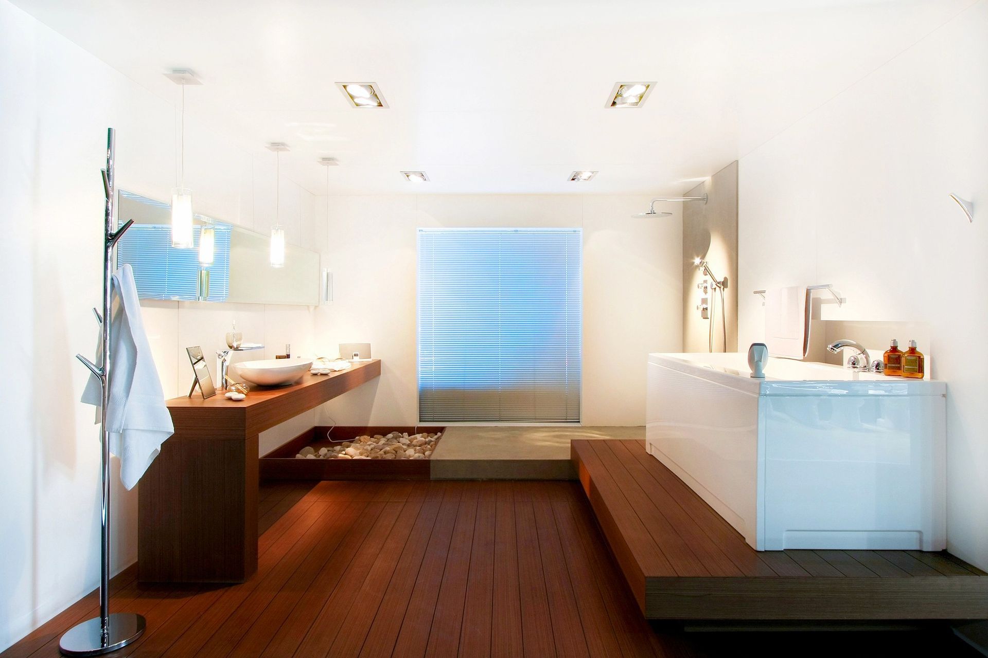 Modern bathroom with freestanding bathtub, stylish sink, and wooden flooring
