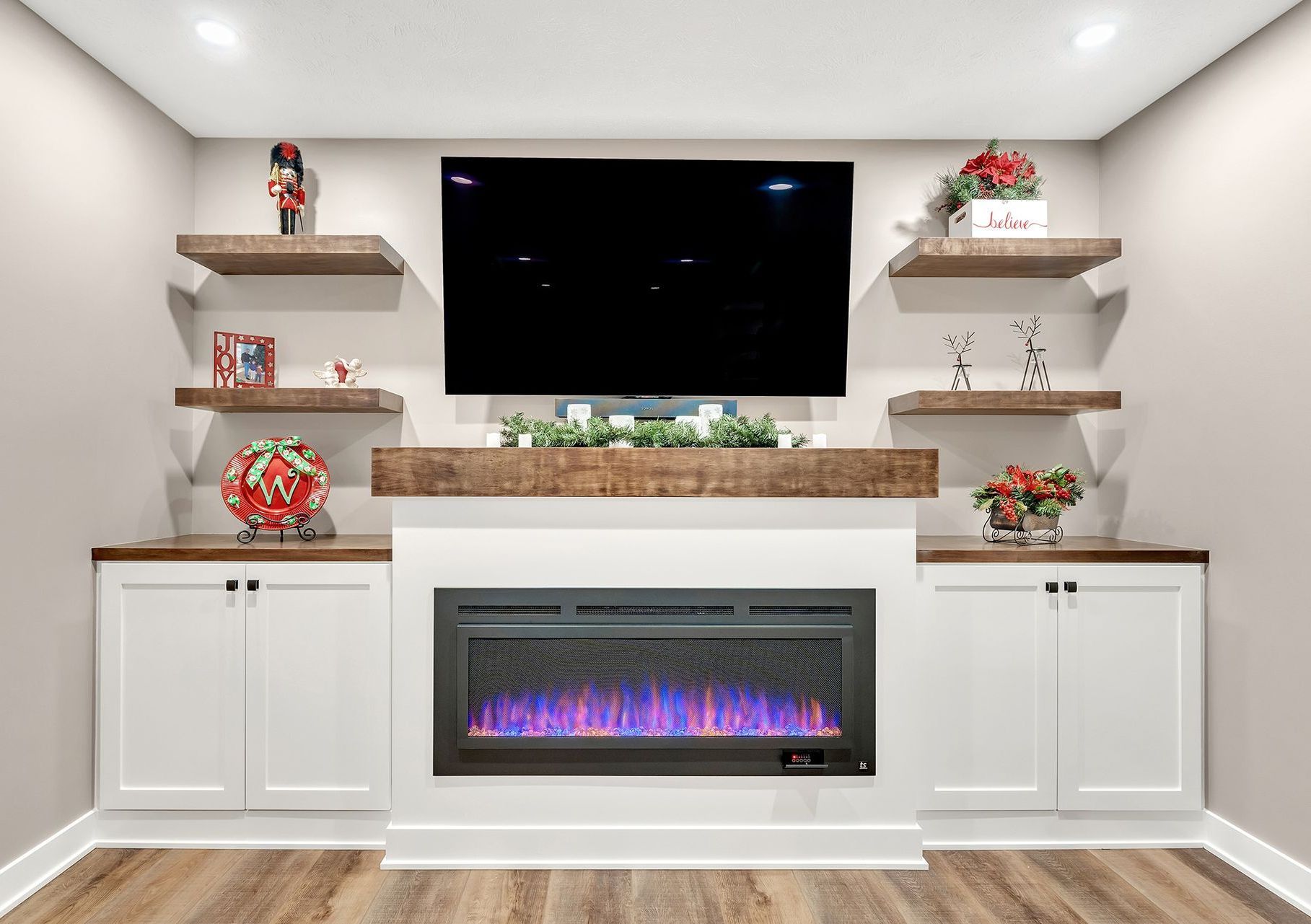 A living room with a fireplace and a flat screen tv.