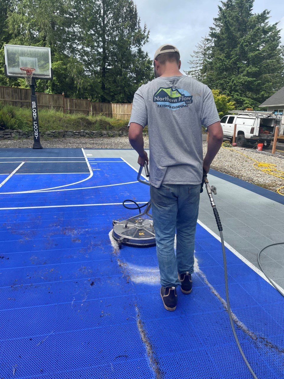 A worker doing exterior soft washing in Olympia, WA