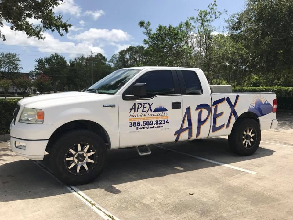 an apex electrical services truck is parked in a parking lot