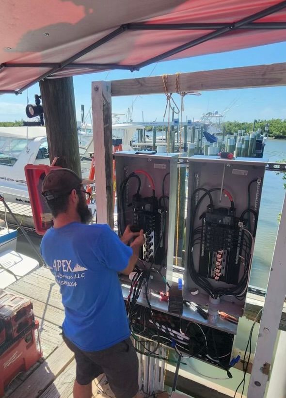 A man in a blue shirt is working on a boat.