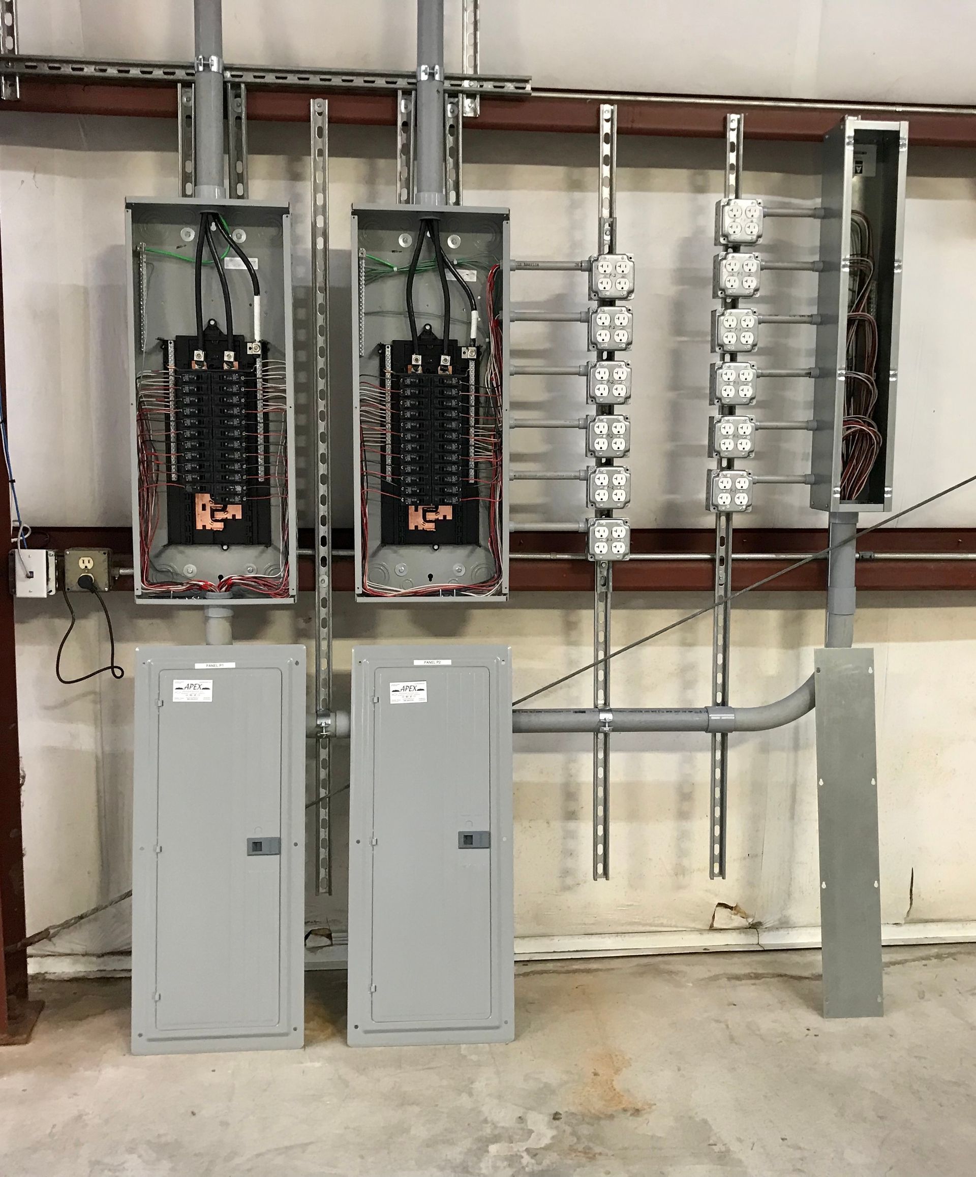 a row of electrical panels are hanging on a wall .