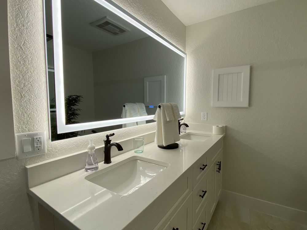 a bathroom with two sinks and a large mirror .