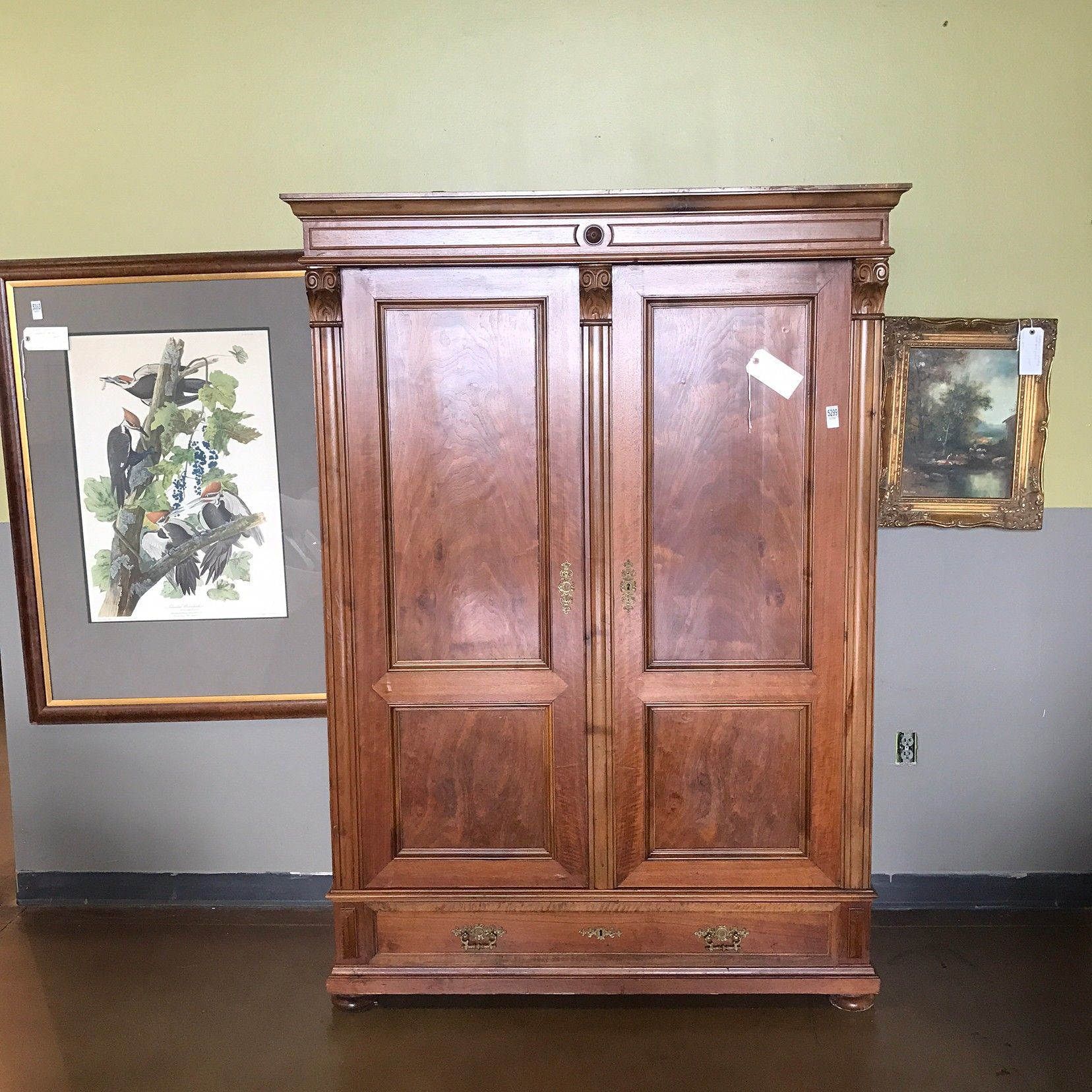 A wooden cabinet with two doors and two drawers in a room