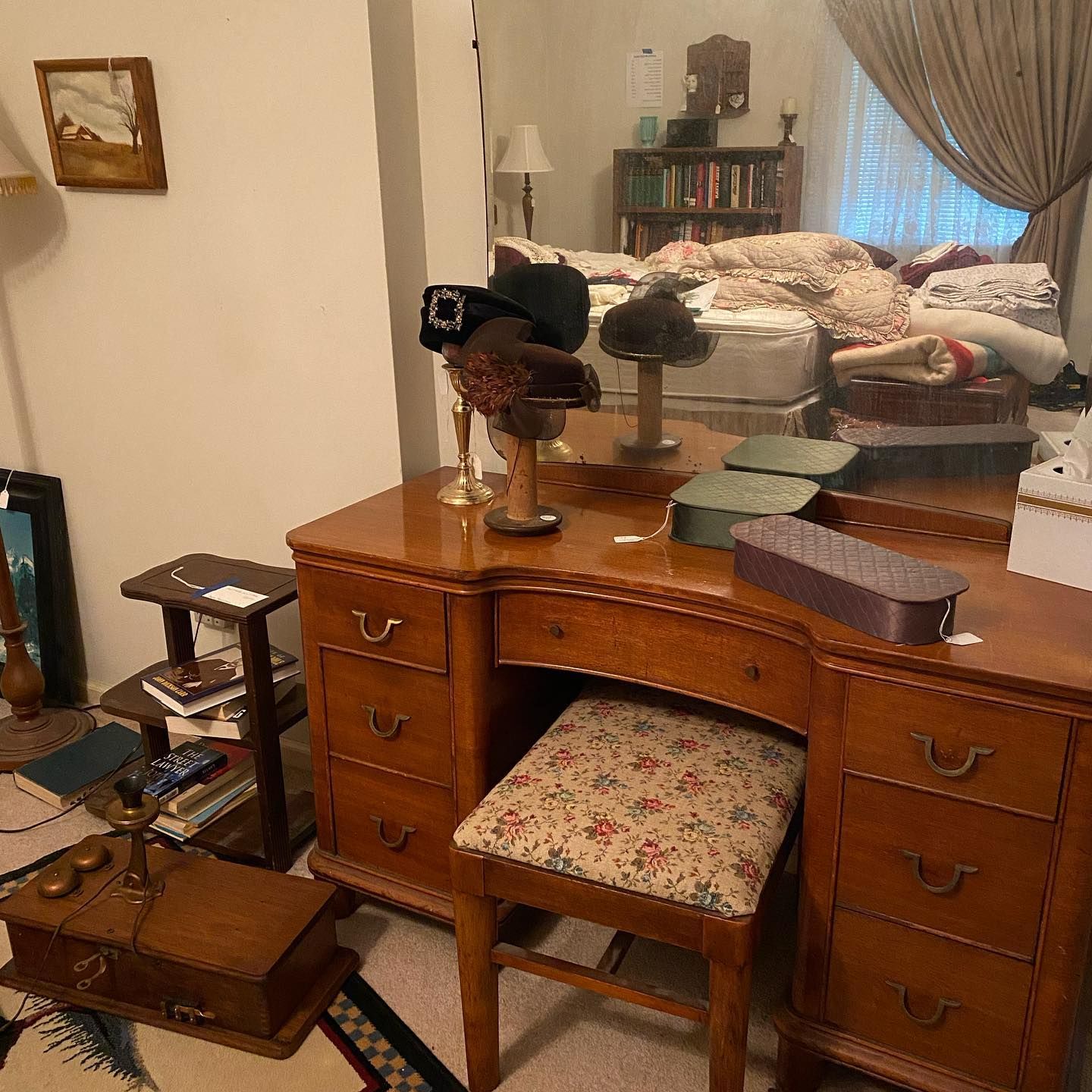A wooden desk with a chair and a mirror in a bedroom