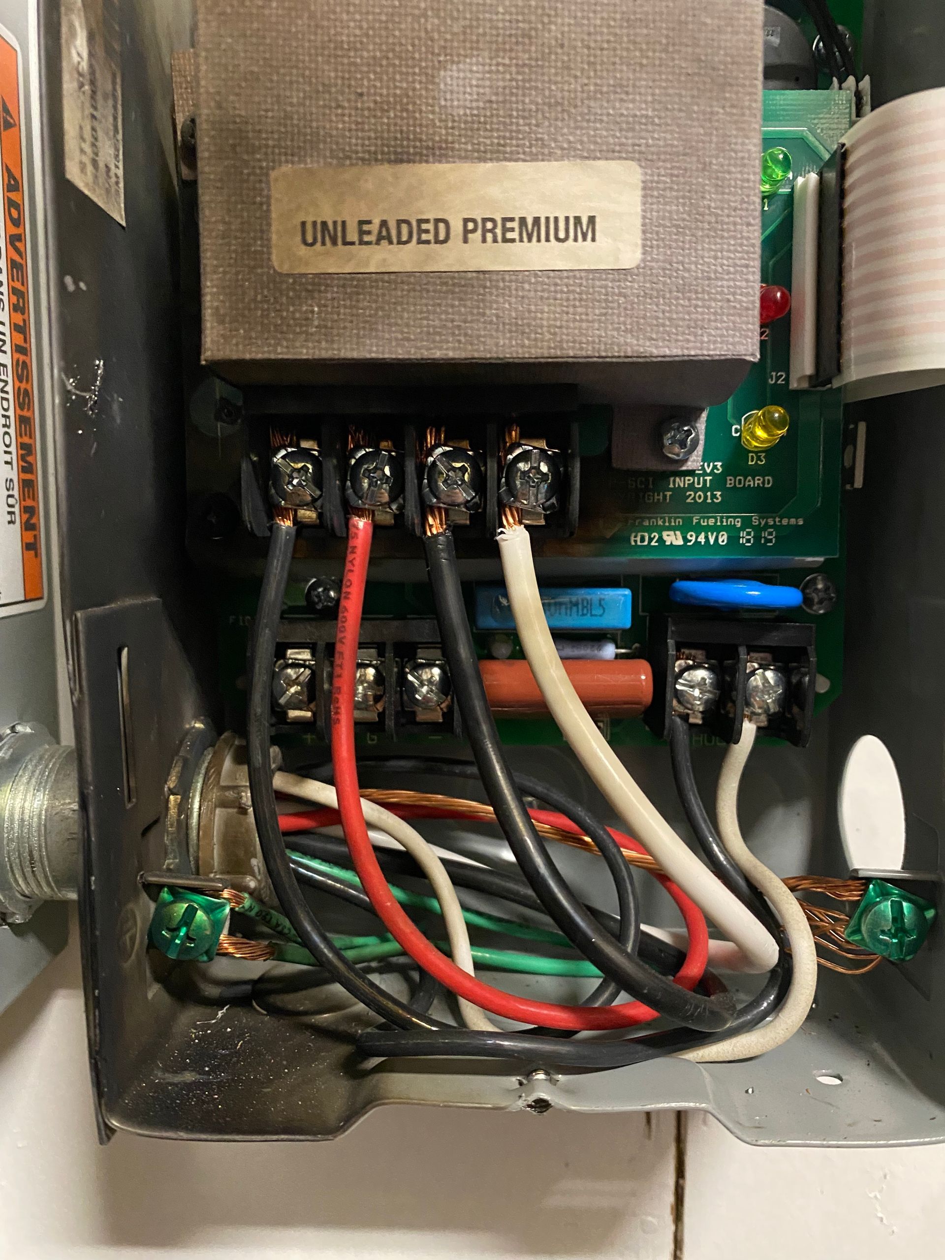 Electrical control box with exposed wiring and a transformer labeled 