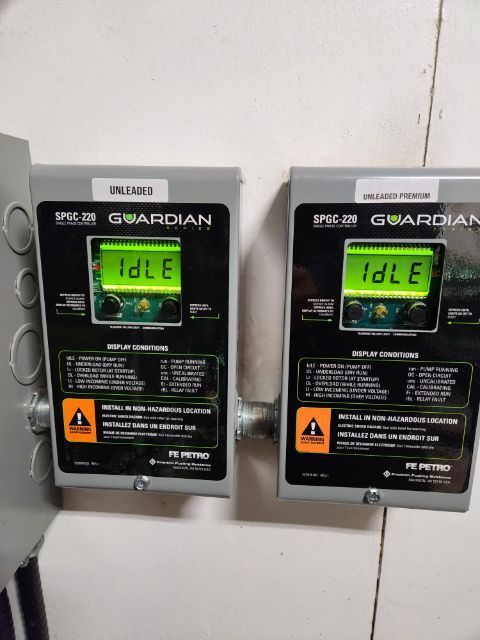 Two gray electronic boxes labeled 