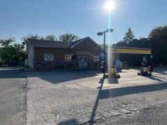 Shell gas station with a convenience store on a sunny day.