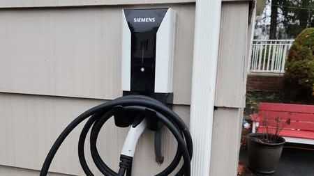 Siemens EV charger professionally installed by JDP Electric on exterior residential wall in Central Jersey.