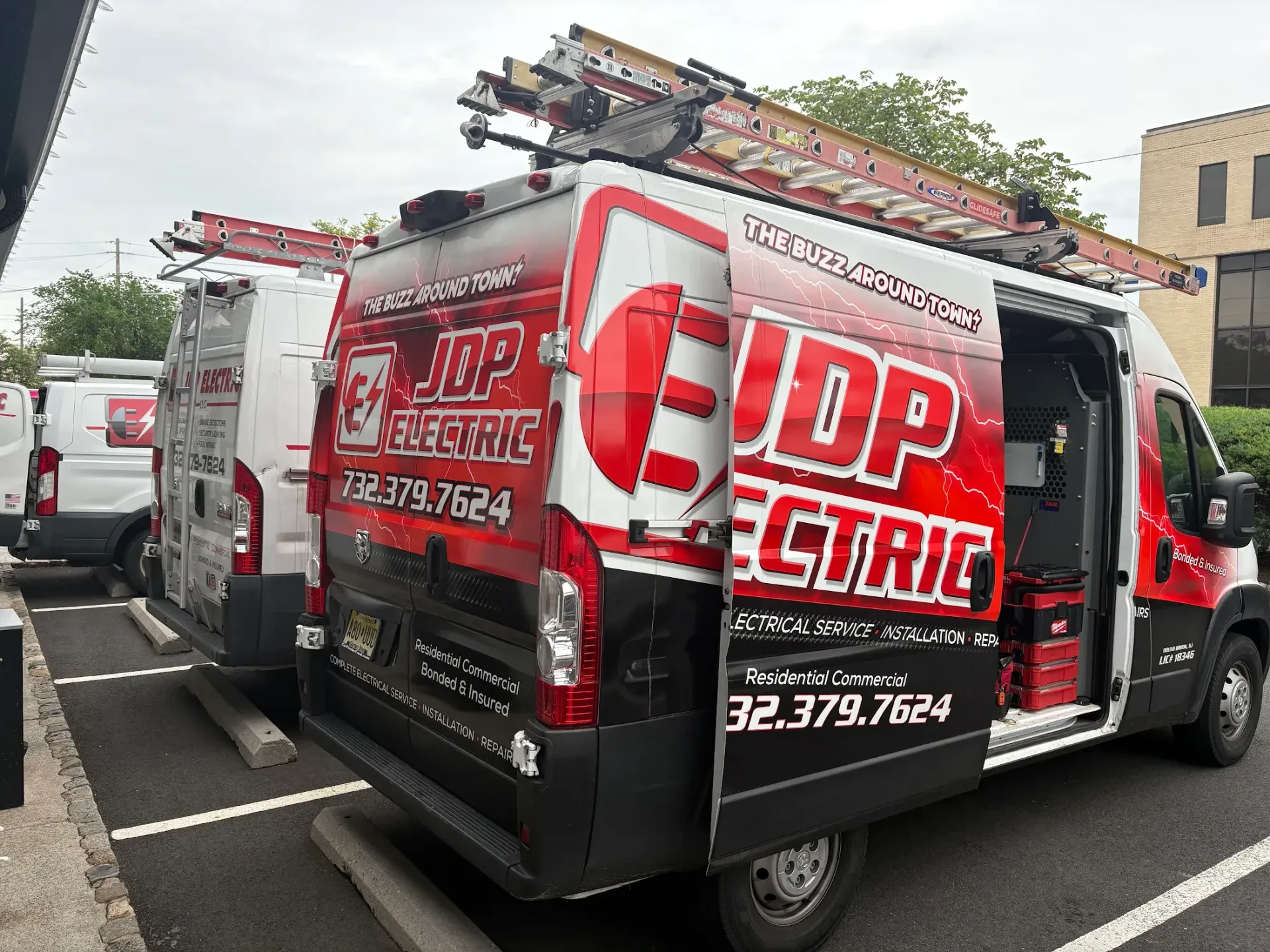 JDP Electric service vans at a residential electrical job site in Clark, NJ