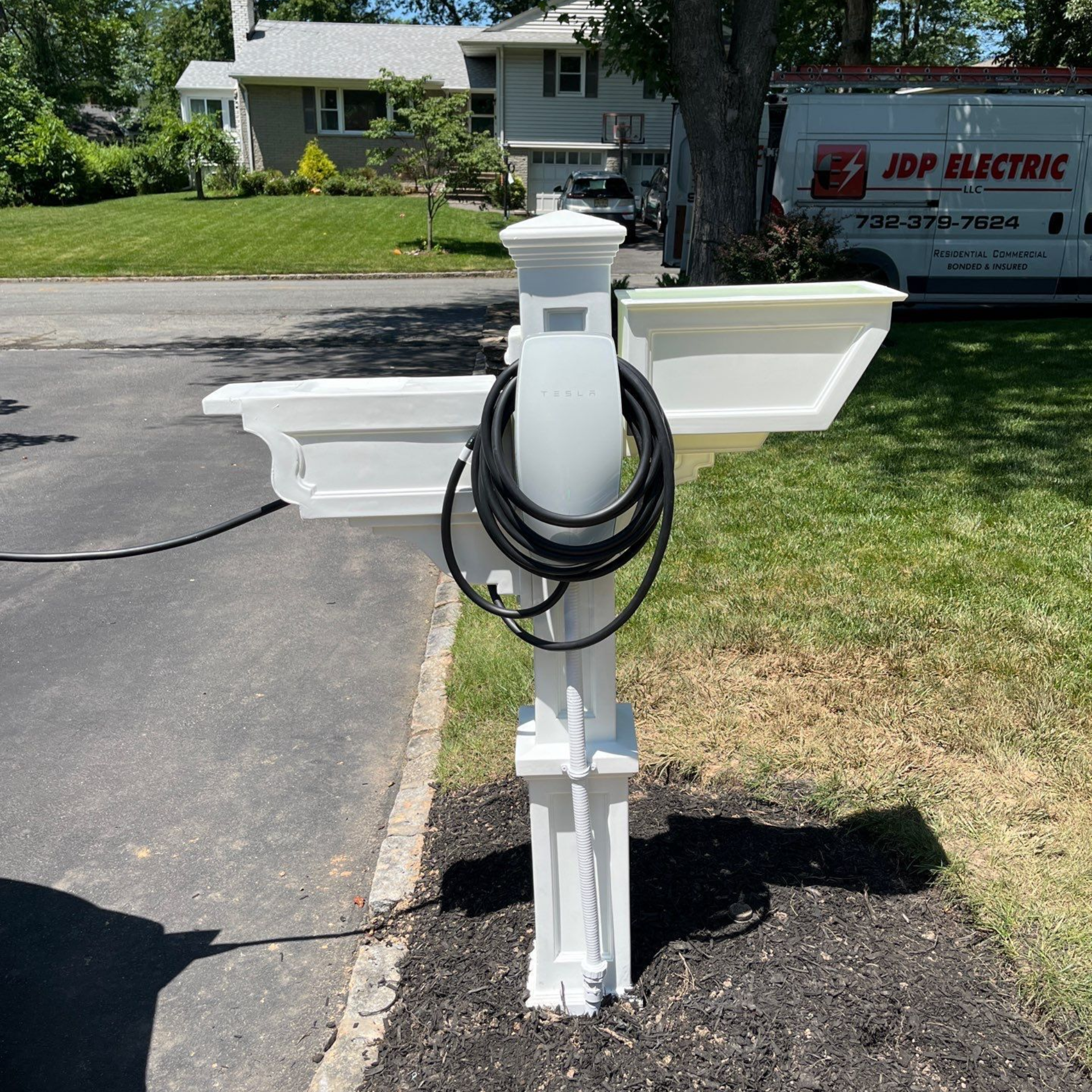Tesla EV charger installation in New Providence, NJ by JDP Electric, mounted on a custom white post with professional wiring