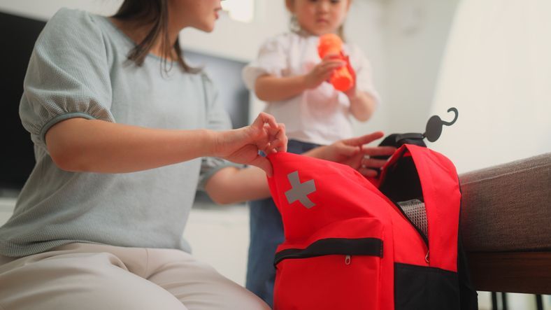 Image of woman and child packing an emergency bag ahead of a hurricane