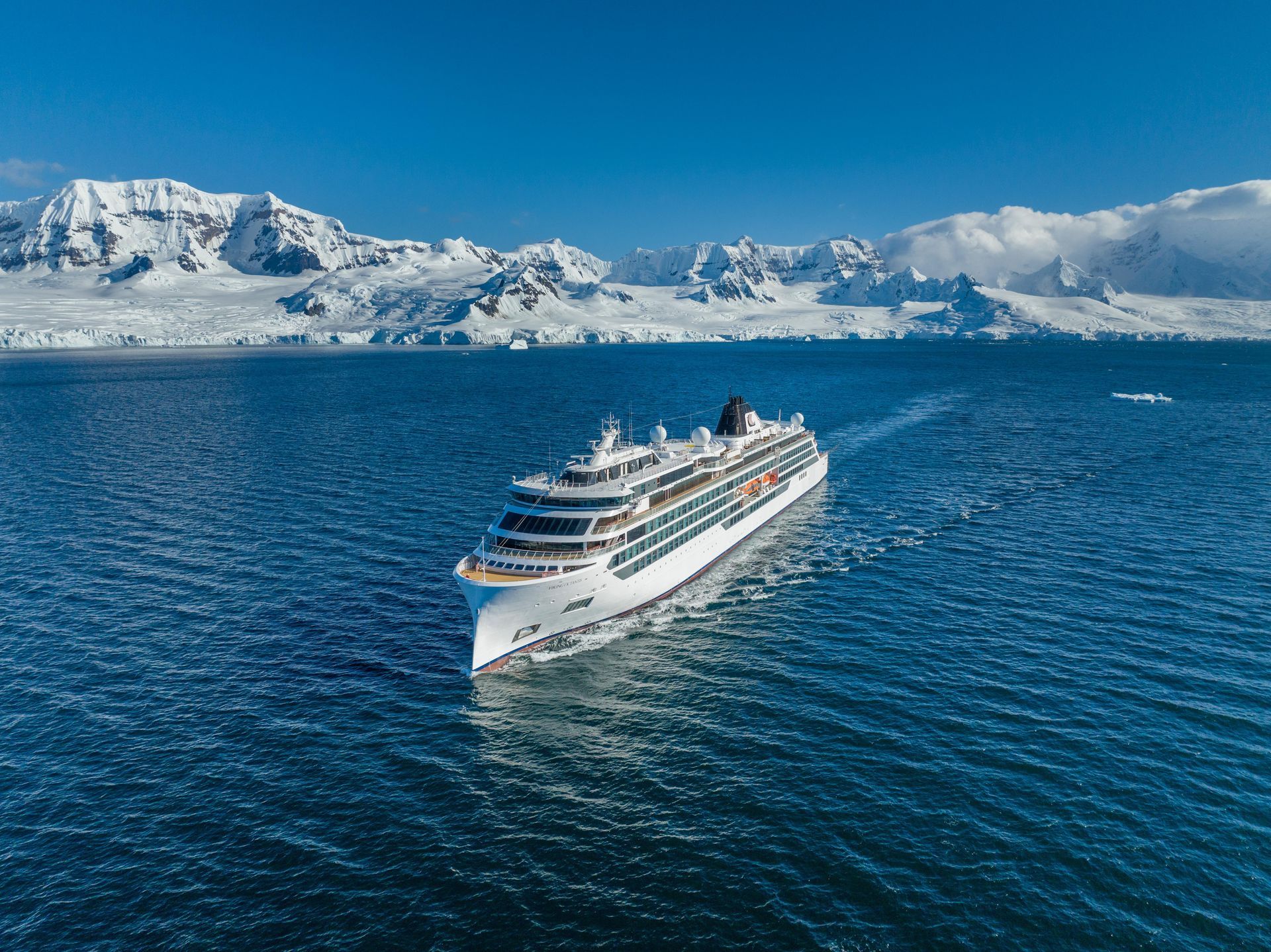 An aerial view of a cruise ship floating on top of a body of water.