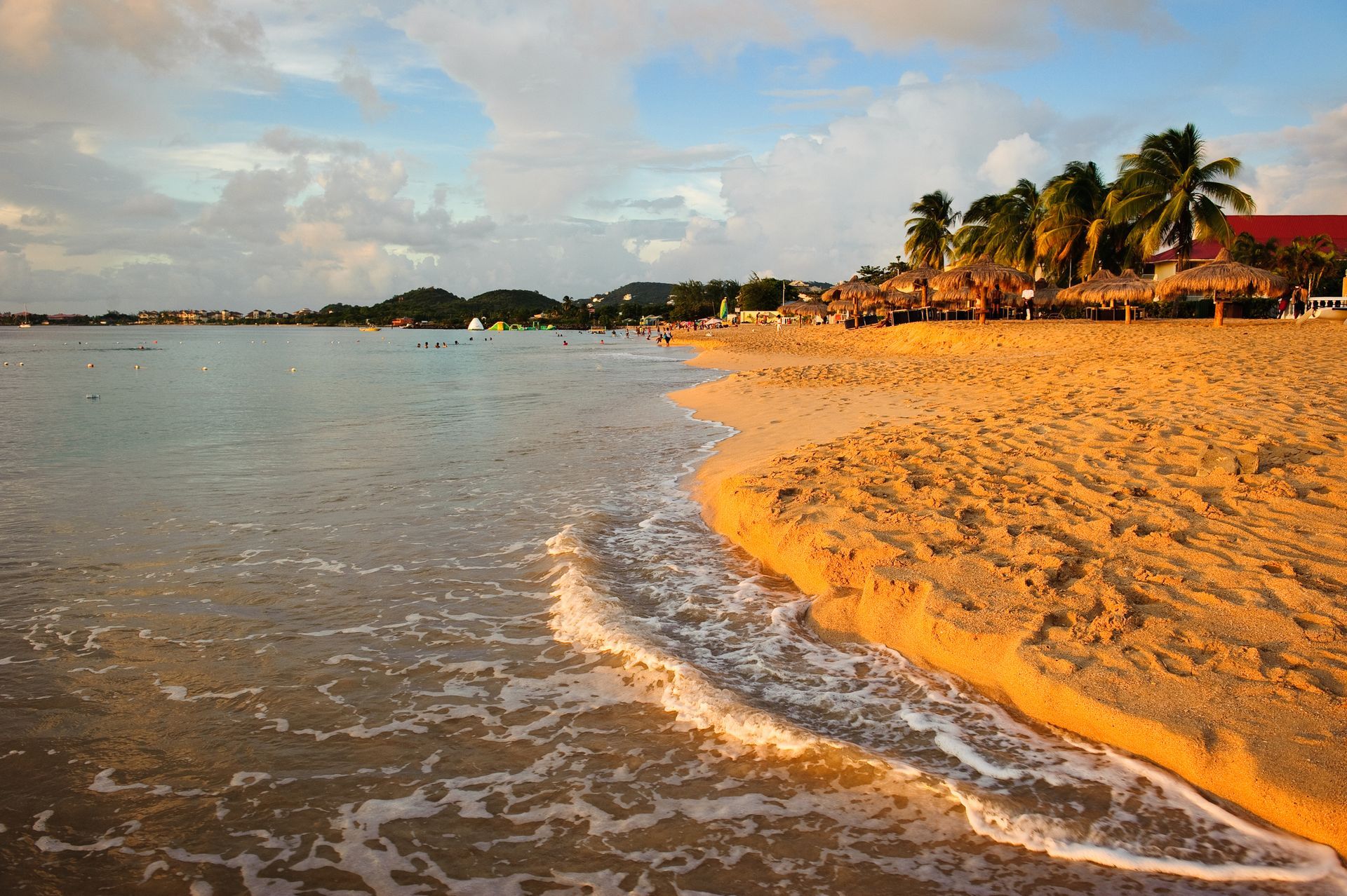 A sandy beach with palm trees in the background