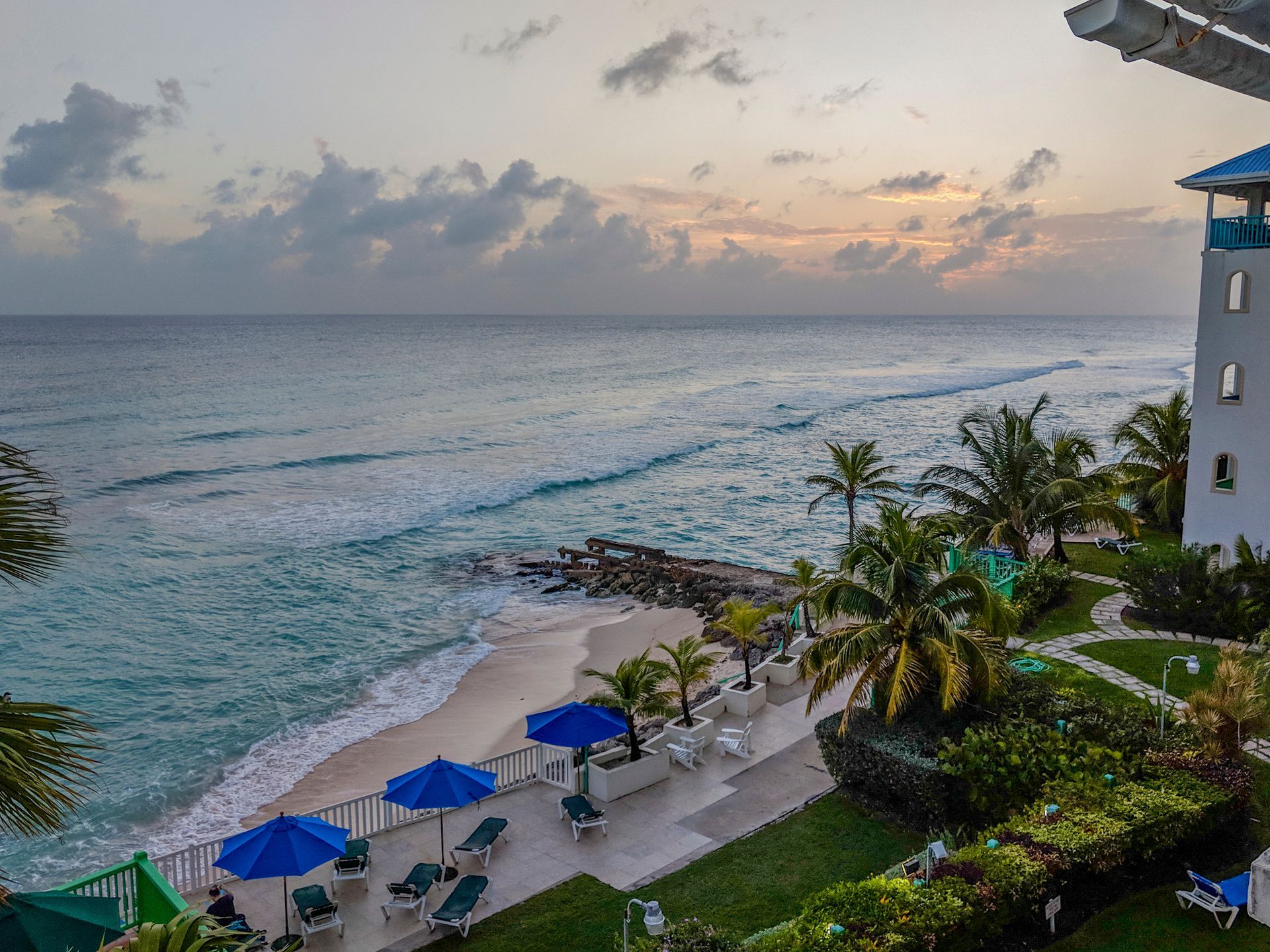 An aerial view of a beach with umbrellas and chairs