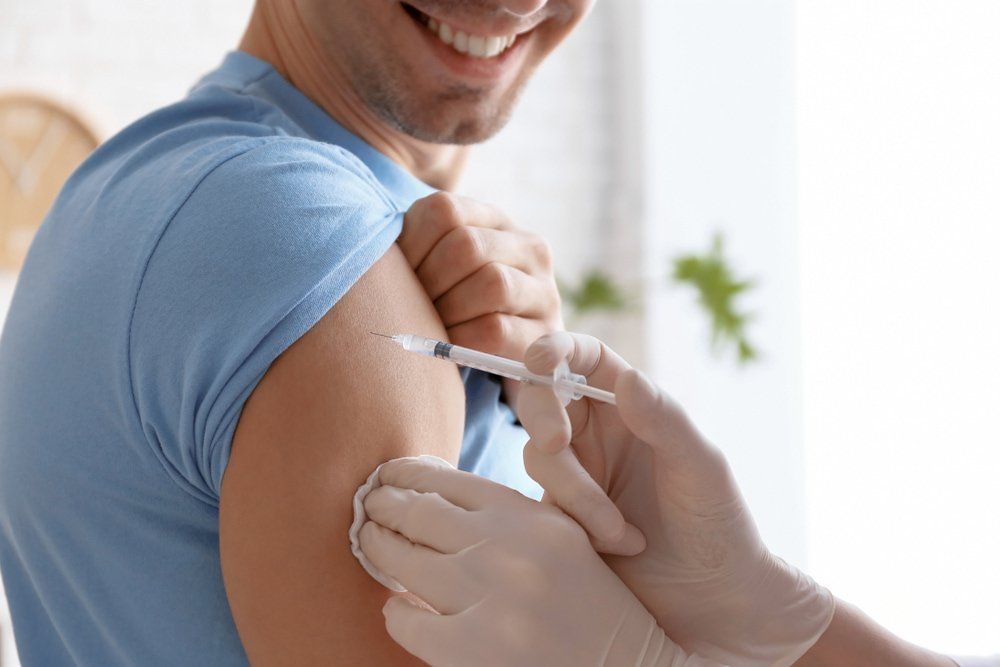 Doctor Vaccinating Male Patient — Doctors in Tuncurry, NSW